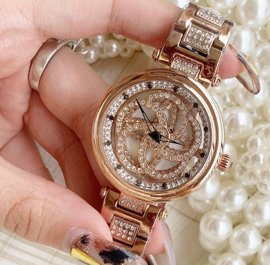 Foreign trade hot style watch female steel watch lady quartz watch to turn the windmill surface douyin the same Dujana147